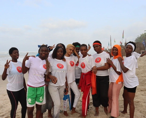 A group posing on the beach.